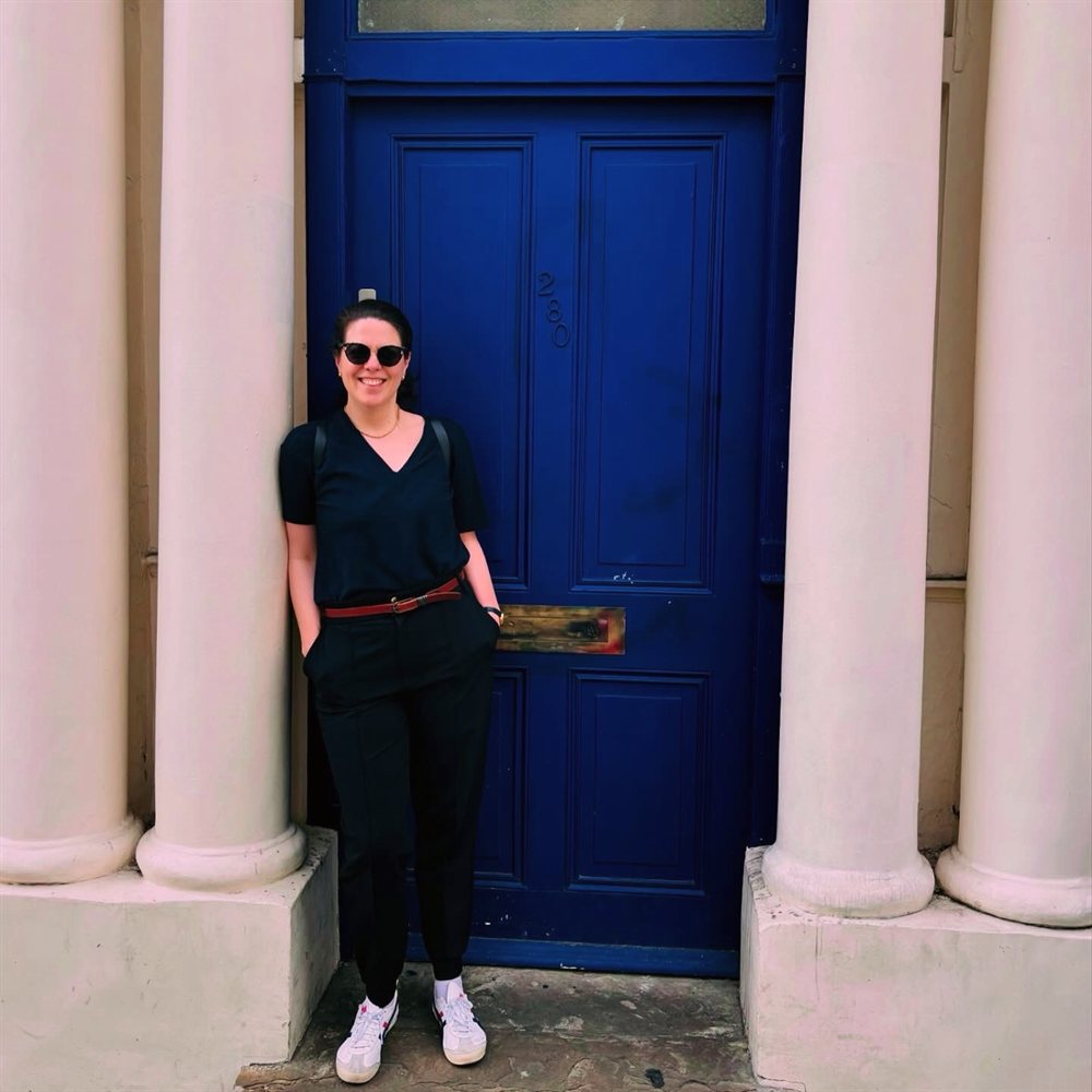 Sabrina Schell in front of a blue door in London